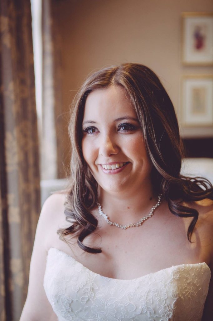 Smiling Bride A bride smiling at her Chester Grosvenor wedding morning after her professional makeup application.