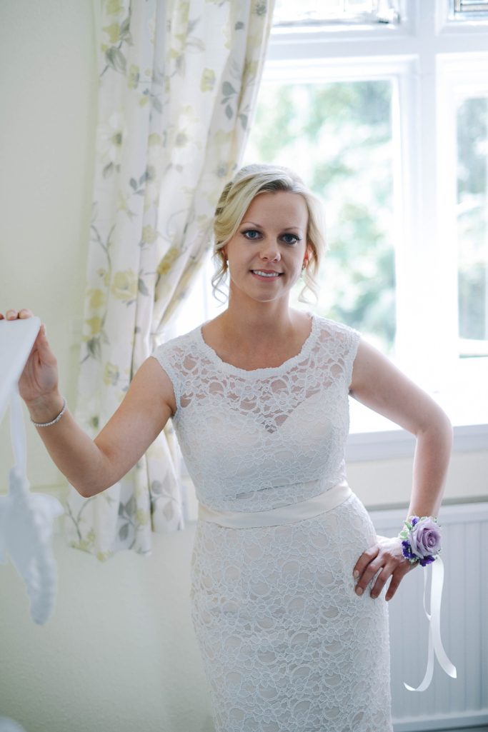 Full image of bride on her wedding day Timeless bridal beauty with soft radiant makeup by Chester wedding makeup artist at Chester Zoo.